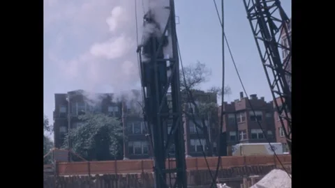 1960s: Men work at construction site.  Apartment buildings. Stock Footage 248547552