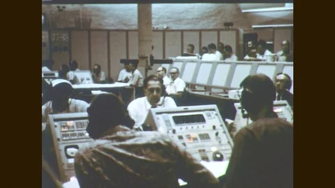 1960s: Men work in control room. Man checks computer readout. Men work on Video stock 77053898