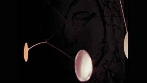 1960s: Metallic discs hanging from string. Nodes on mobile extending from Video stock 174735281