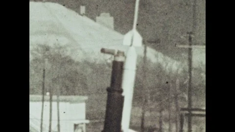 1960s: model rocket launches with flames as string dangles from end. balloon Stock Footage 102694583