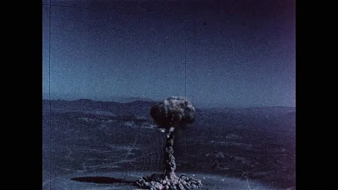 1960s: Mushroom cloud from atomic bomb explosion in desert rises into sky. Stock Footage 159489593