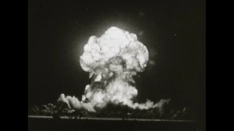 1960s: mushroom cloud rises into dark sky as atomic bomb explodes 動画素材 129971912