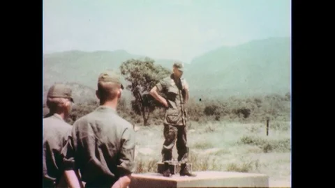 1960s: Officer speaks on platform, soldiers in foreground. Stock Footage