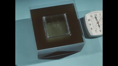 1960s: Overhead view. Time on clock advances half an hour. Square form with Stock Footage 275727828