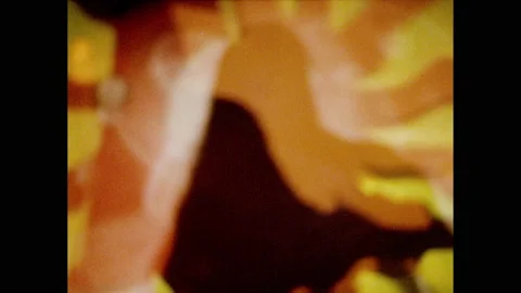 1960s: Overlapping female dancing figures against a sun and irregular multicolor Stock Footage 157461000