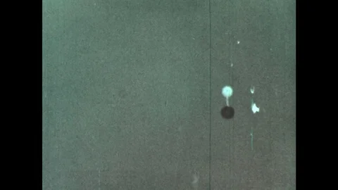 1960s: Parachute deploys from capsule. John Glenn sits in capsule, talks. Stock Footage 77410007