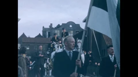 1960s: Parade with men carrying flags. Horse drawn carriage with men in uniform. Stock-Footage 246454138
