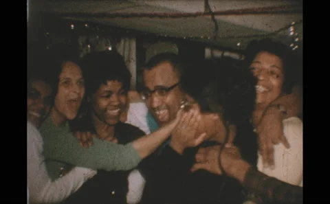 1960s: Party.  People sway together and sing.  Couple kisses. Stock Footage 146599208