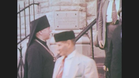 1960s: People exit church. Jewish synagogue. Clergy reading book. St. Patrick's Stock Footage