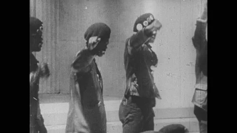1960s: People stand in rows, chanting at Black Panthers rally in front of Video stock 153548918