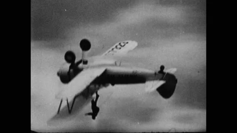 1960s: Pilot in Wright Brother's plane. Airplane flies upside down. Airplane Stock Footage 159799076