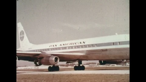 1960s: Plane moves down runway / Montage of airport signs for various airlines. Stock Footage