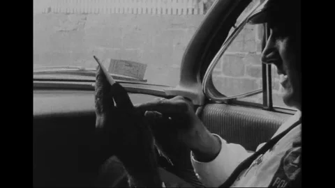 1960s - Policemen pull over a driver and give him a ticket. Stock Footage