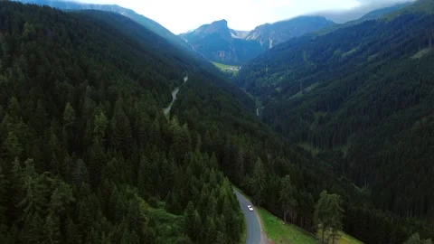 1960s Pontiac Oldtimer Driving Through Forested Valley in Tyrol – Aerial View Video stock 314031906