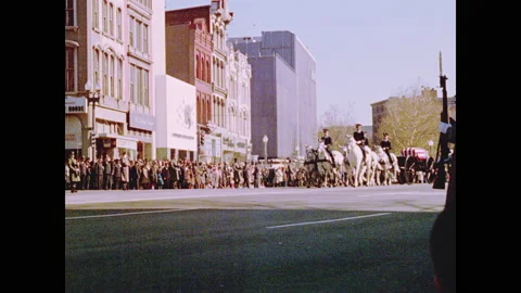 1960s: Priests lead horses pulling carriage with casket for funeral procession Stock Footage 143690294