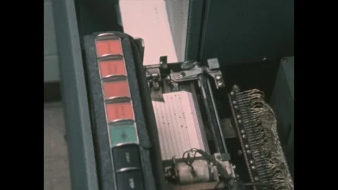 1960s: Printing machine prints punch hole cards. Dot matrix printer prints on 動画素材 276504414