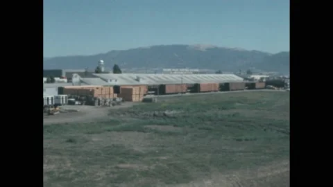 1960s: Processing plant.  Parking lot.  People dump fruit into water.  Fruit Stock Footage 172028456