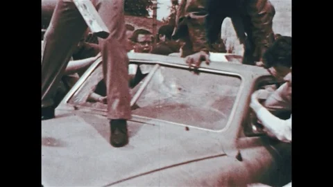 1960s: As protesters jump on and rock a car, the police riot unit starts Stock Footage 74489134