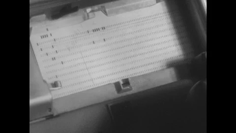 1960s: Punch card in machine. Close up, hand holding stack of punch cards. Stock Footage 94465550