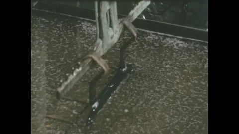 1960s: Rack of metal speaker forms rise from electroplating bath in factory. Stock Footage 246750118