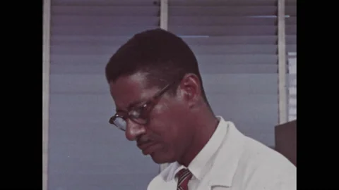 1960s: Researcher. Polygraph machine records blood pressure reading. Researcher Stock Footage 137835868
