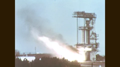1960s: Rocket booster ignites on launch pad. Rocket booster engine fires. Stock Footage 77051690