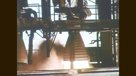 1960s: Rocket engine test fires. Men move rocket engine. Men adjust rocket Stock Footage 77050316