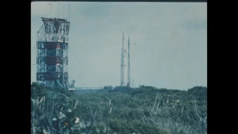 1960s: Rocket launches in field. Control tower nearby. Stock Footage 277654027