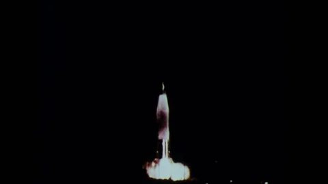 1960s: Rocket launches from platform into sky at night. Video stock 126014023