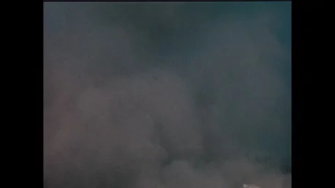 1960s: Rocket launchpad surrounded by smoke. Smoke clears and rocket launch Stock Footage 277654742