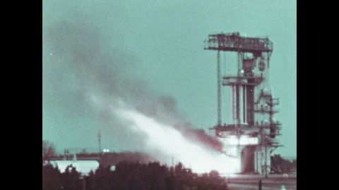 1960s: Rocket's engines ignite on launch pad. Rocket engines burn. Engines Stock Footage 104881315