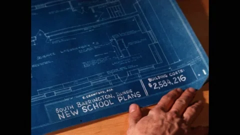 1960s: roll of paper on table. Blue print of school. South Barrington School Stock Footage 219965720