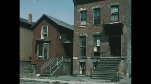 1960s: Run down two-story building with broken window next to house. Stock Footage 275772034