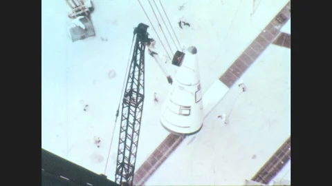 1960s: The Saturn C-1 rocket nose cone is hoisted at the launch site. NASA Stock Footage 79245708