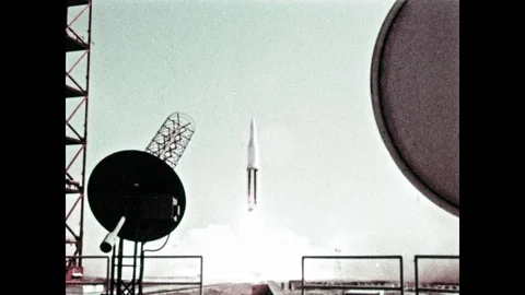 1960s: Saturn C1 rocket liftoff. Man operates camera. Saturn C1 rocket flies in Stock Footage 101403770