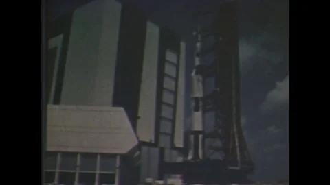 1960s: Saturn V rocket on launch platform near building. Saturn V rocket on Vídeos de archivo 84905525