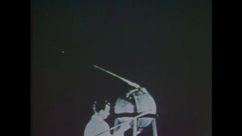 1960s: Scientist operates Sputnik 1 satellite. Space rocket takes off, smoke. Stock Footage 85177380