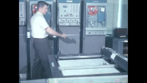 1960s: Scientist pushes buttons on computer in forecasting station. Printer Stock Footage 247522462