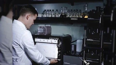 1960s SCIENTIST Reads LABORATORY Data Print-out Graph Vintage Retro Film Movie Stock Footage 84253640