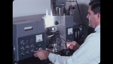 1960s: Scientist turns knobs on machine and examines flames from jet fuel in 스톡 동영상 110814956
