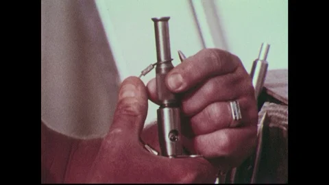1960s: Scuba diver demonstrates loading the pole spear tip with a bullet. Stock Footage 90737740