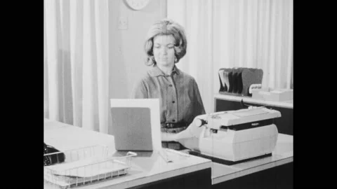 1960s: secretary reading off transcript while she types it, secretary reading Stock Footage 143973096