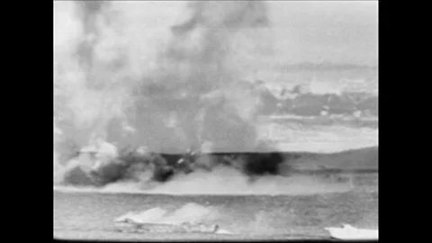 1960s: Ships explode.  Soldiers arrive at beach in small boat.  Men run.  Smoke. Video stock 128192500