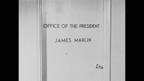 1960s: Sign on door, man opens door, man enters, men shake hands, zoom in, men Stock Footage 145208151