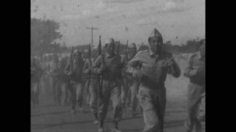1960s: Soldiers in marching, start to run. Soldiers carrying cargo up hill. Stock Footage 234545169