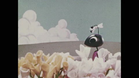 1960s: Stop-motion animation. Grasshopper lazes around. Girl ants collect and Stock Footage 155857688