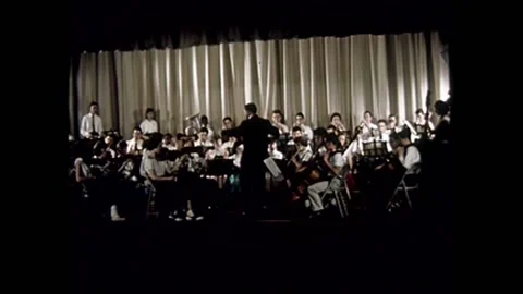 1960s - A student orchestra plays in Music class in a NYC junior high school. Stock Footage
