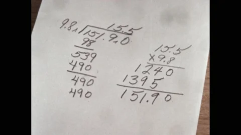 1960s: student workings out for maths problem. Mathematical equation in pencil Stock Footage 219965647