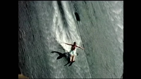 1960s Surfing, man slides down the face of a dam wall. Video stock 152014690