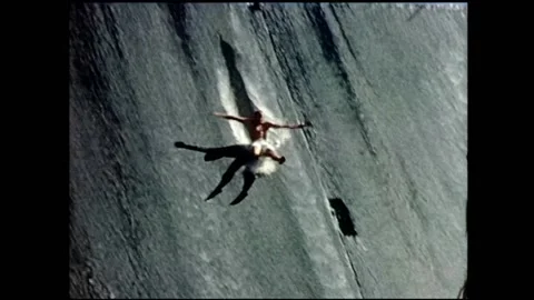 1960s Surfing, man slides down a dam wall. Video stock 152014707
